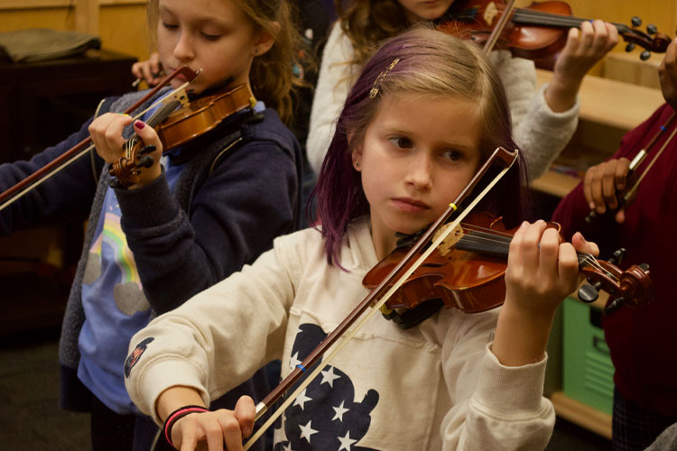 Students at The Caedmon School playing the violin