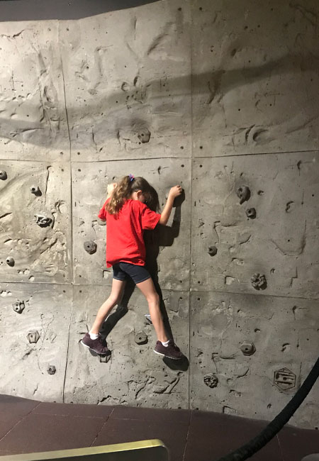 Student rock climbing at discovery camp